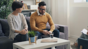 couple sitting apart in a quiet space feeling emotionally distant